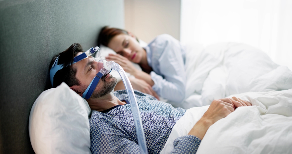 man wearing cpap machine